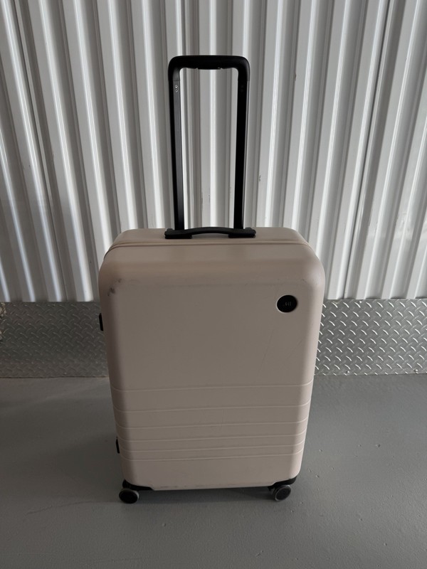 MONOS Hard Shell Checked Bag Pockets Rolling Travel Luggage Suitcase – 26 Inch