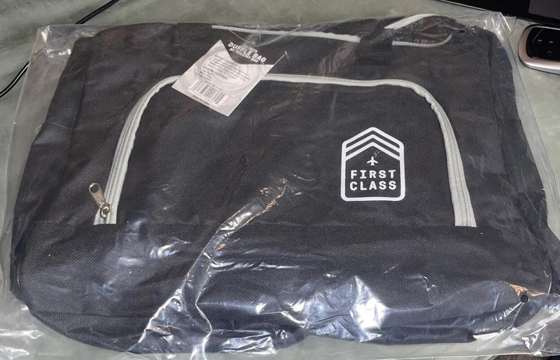 First Class 20 Inch Duffle Bag. New With Tags. Black And Beige. Pockets. Zipper