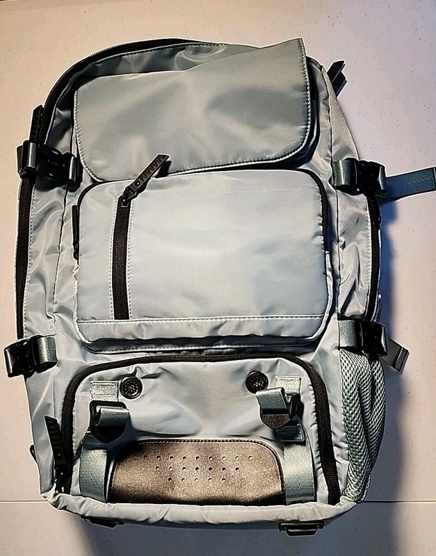 Travel backpack with multiple compartments and carrying options, light blue