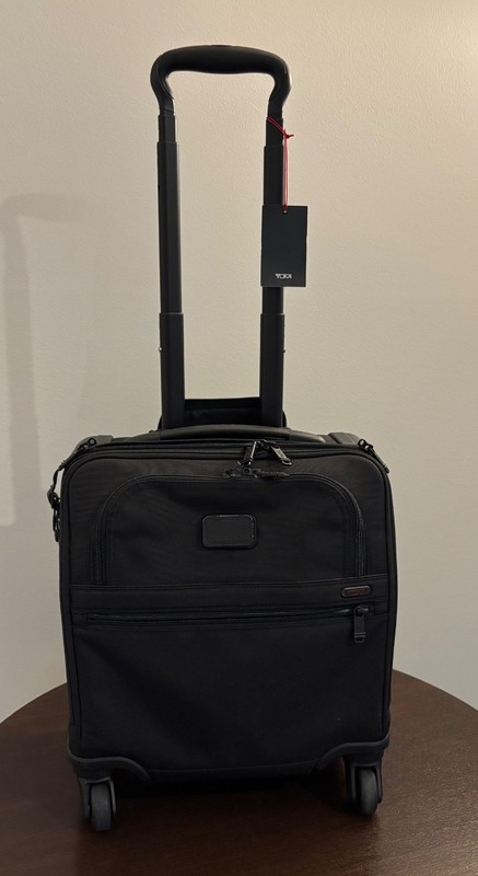 TUMI black underseater with spinner wheels. Excellent condition. Used once.